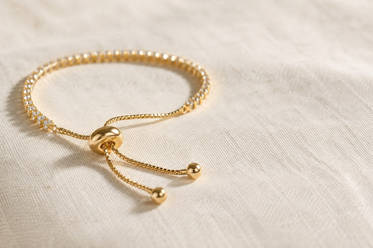Close-up of the sliding closure on an adjustable gold tennis bracelet