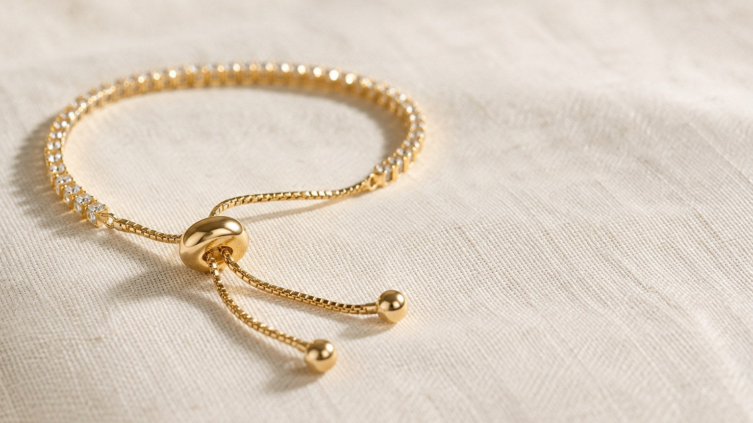 Close-up of the sliding closure on an adjustable gold tennis bracelet
