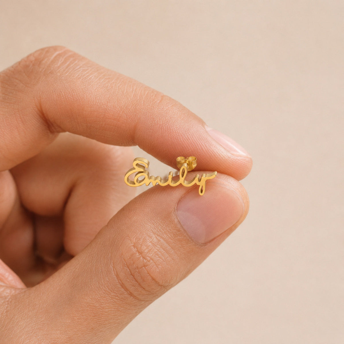 Customized Name Earrings held between fingers