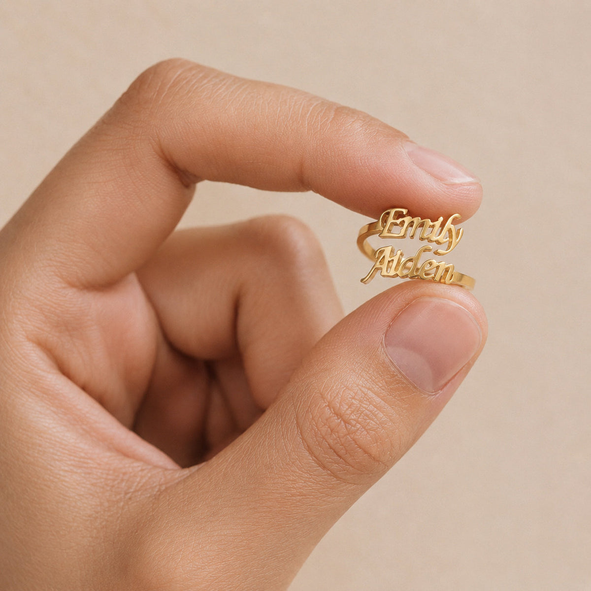 Customized Name Ring held between fingers