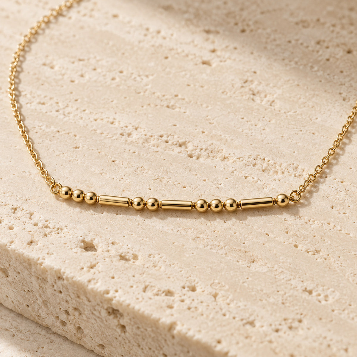 Close-up of Morse code beads on necklace