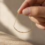Morse Code Necklace held between fingers