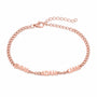 Name bracelet with three names in block capitals in rose gold on a white background