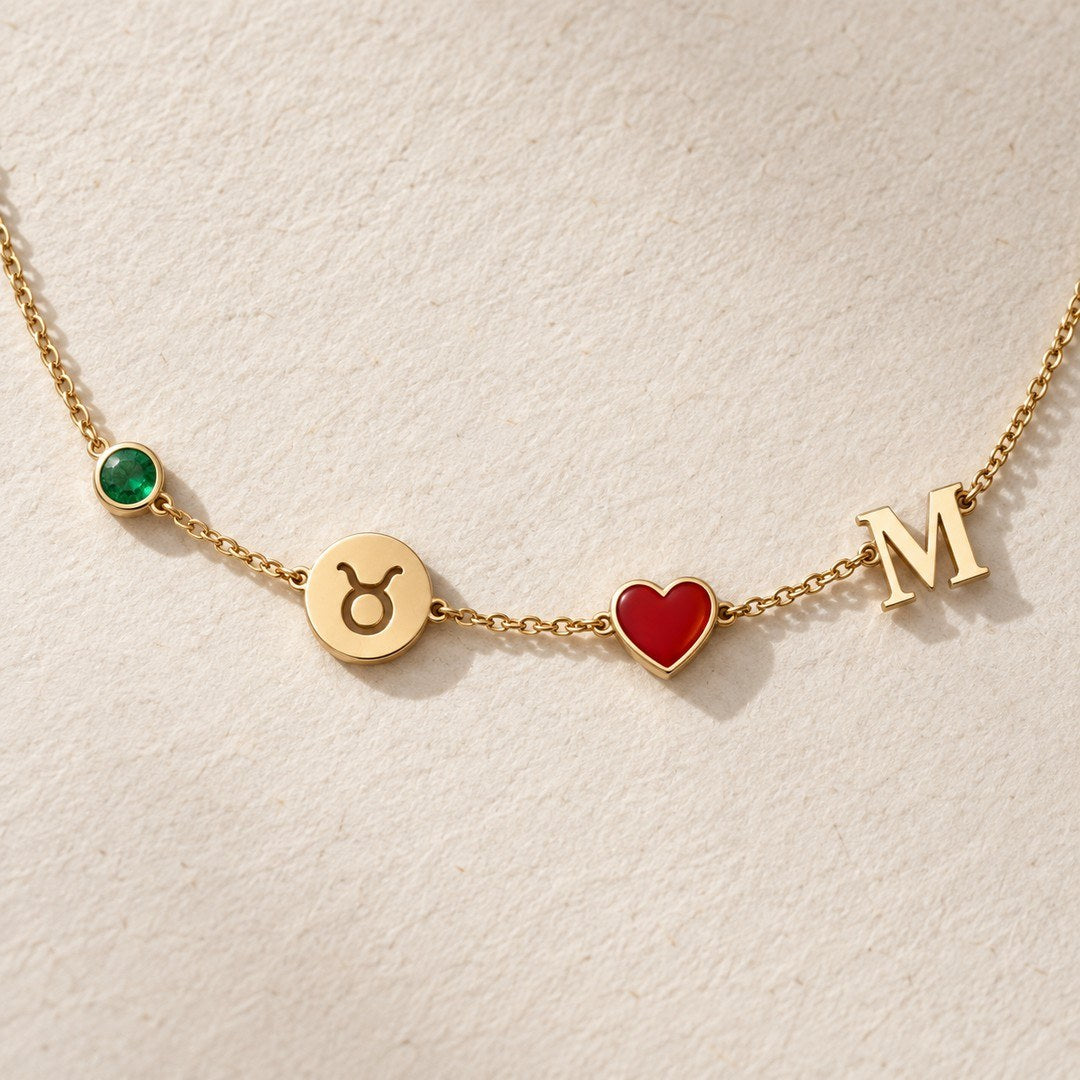Close-up of birthstone, zodiac, heart and initial charms on necklace
