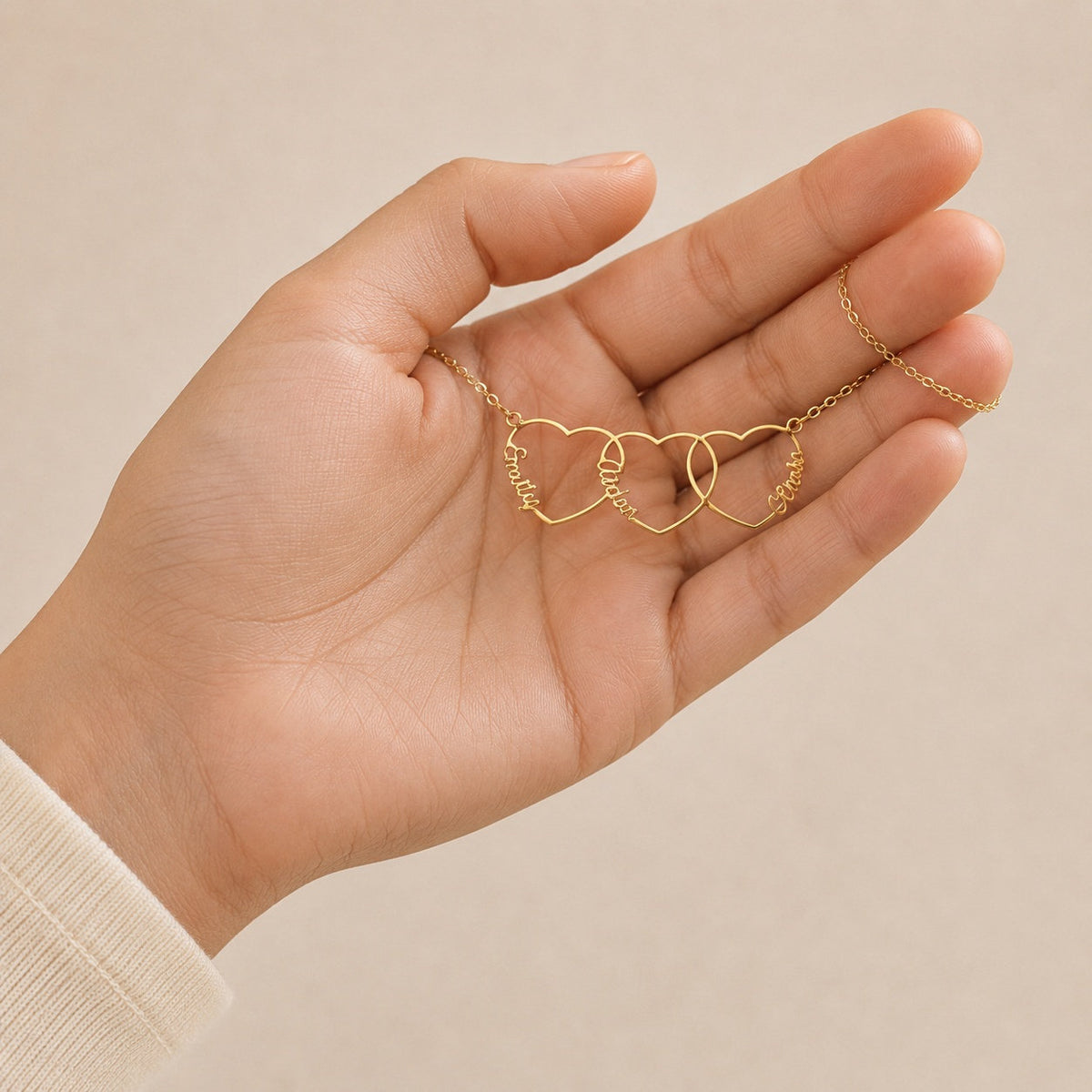Personalized Heart Name Necklace draped across the hand